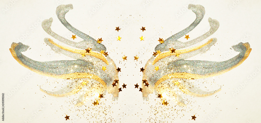 Glitter and glittering stars on abstract gold and black watercolor wings in vintage nostalgic colors. Glitter and glittering stars on abstract gold and black watercolor wings in vintage nostalgic colors.