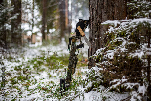  hunting tourist crossbow, a knife stuck in a pine against the background of a winter forest