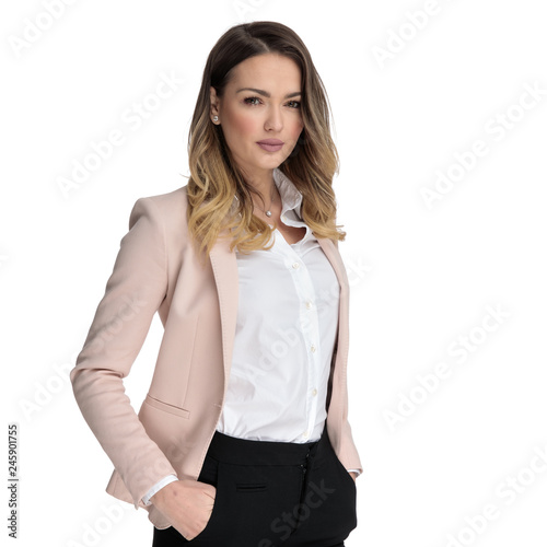 portrait of relaxed businesswoman standing with hands in pockets