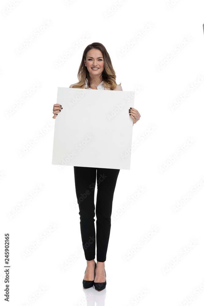 young businesswoman standing and holding empty sign young businesswoman standing and holding empty sign