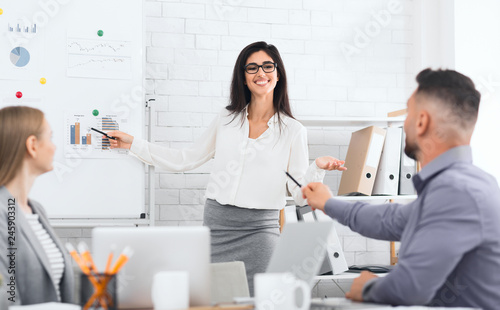 Businesswoman presenting new business plan to colleagues