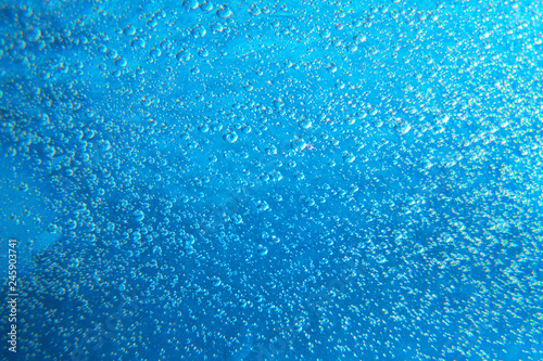 Drops of water on the glass. Marine abstract background. Air bubbles texture