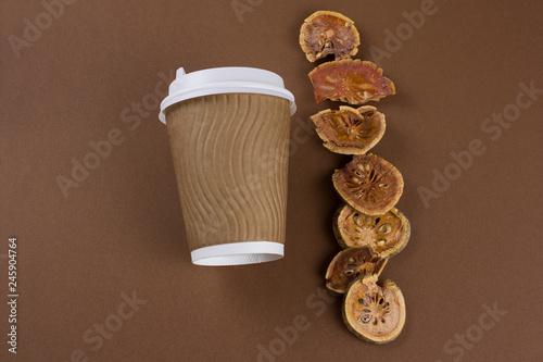 top view matum take away tea and dried bael fruits flat lay on brown background photo