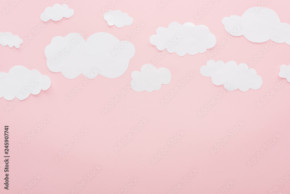 top view of white paper clouds isolated on pink with copy space top view of white paper clouds isolated on pink with copy space