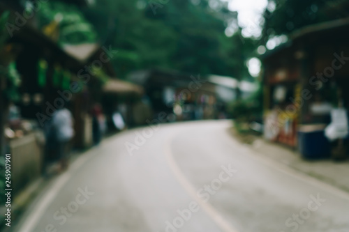 Blur street small village in mountain evening time with people relax and chill out on vacation day.