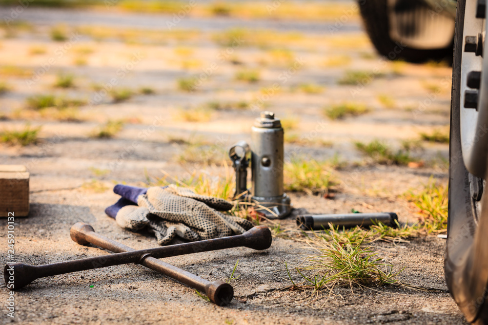 Socket wheel wrench and jack lying on ground Socket wheel wrench and jack lying on ground