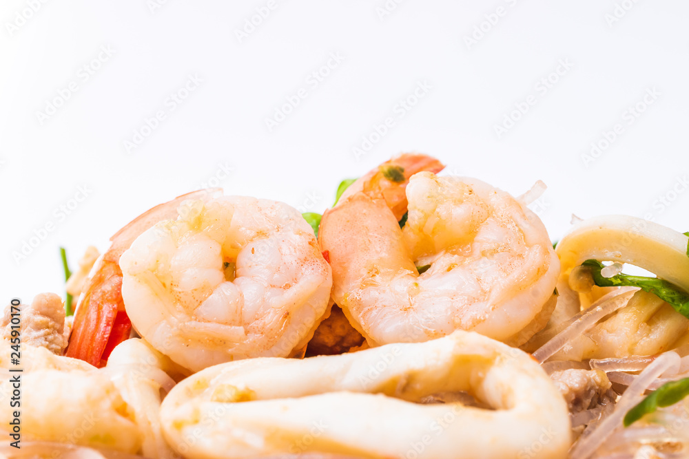 close up of shrimp on spicy salad with squid