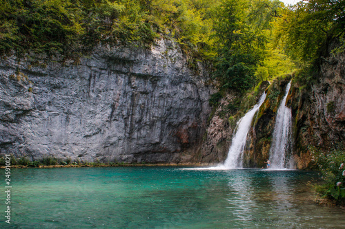 The main natural landmark of Croatia is the Plitvice Lakes with cascades of waterfalls. Emerald clear cold water on the background of rocks, plants and trees.