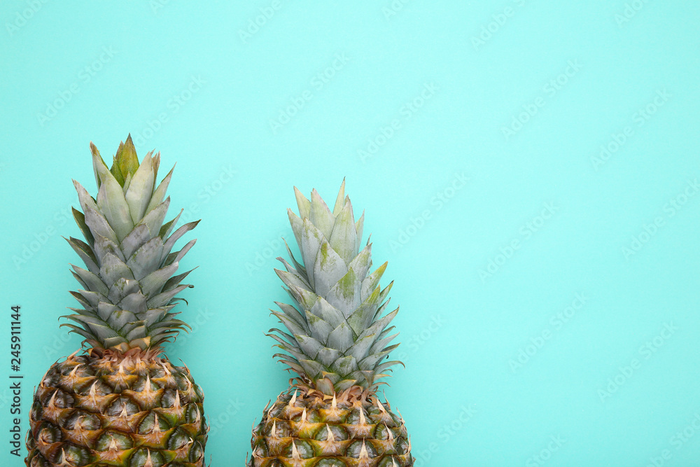Ripe pineapples on a mint background
