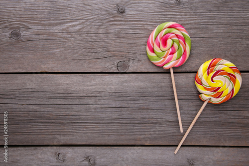 Colorful lollipops on grey wooden background, sweet candy concept