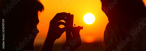 Fotografia, Obraz Banner of silhouette of marriage proposal at sunset