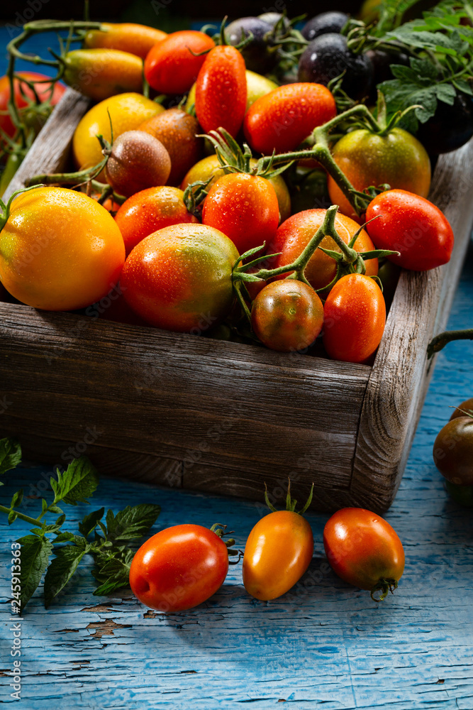 Fresh tomatoes set in wooden box Fresh tomatoes set in wooden box