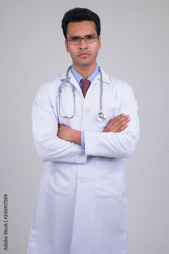 Portrait of young Indian man doctor with arms crossed Portrait of young Indian man doctor with arms crossed