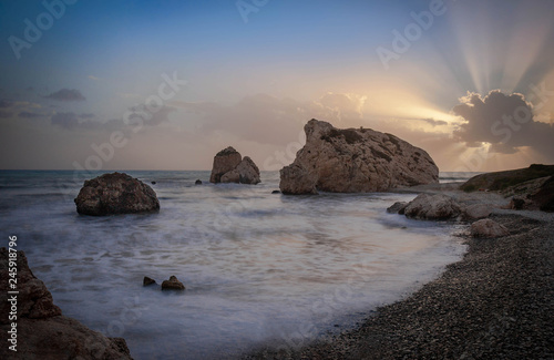 A landscape photo of the sea overlooking the cliffs during sunset hour.