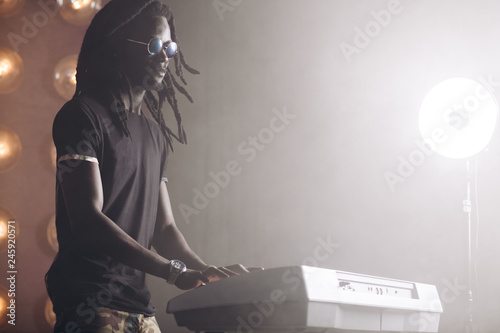 blind musician playing the musical keyboard. close up side view photo.copy space. musical taste.