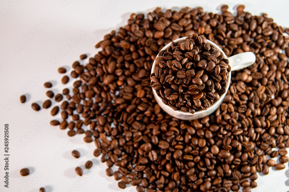 white cup with a pattern and coffee beans white cup with a pattern and coffee beans