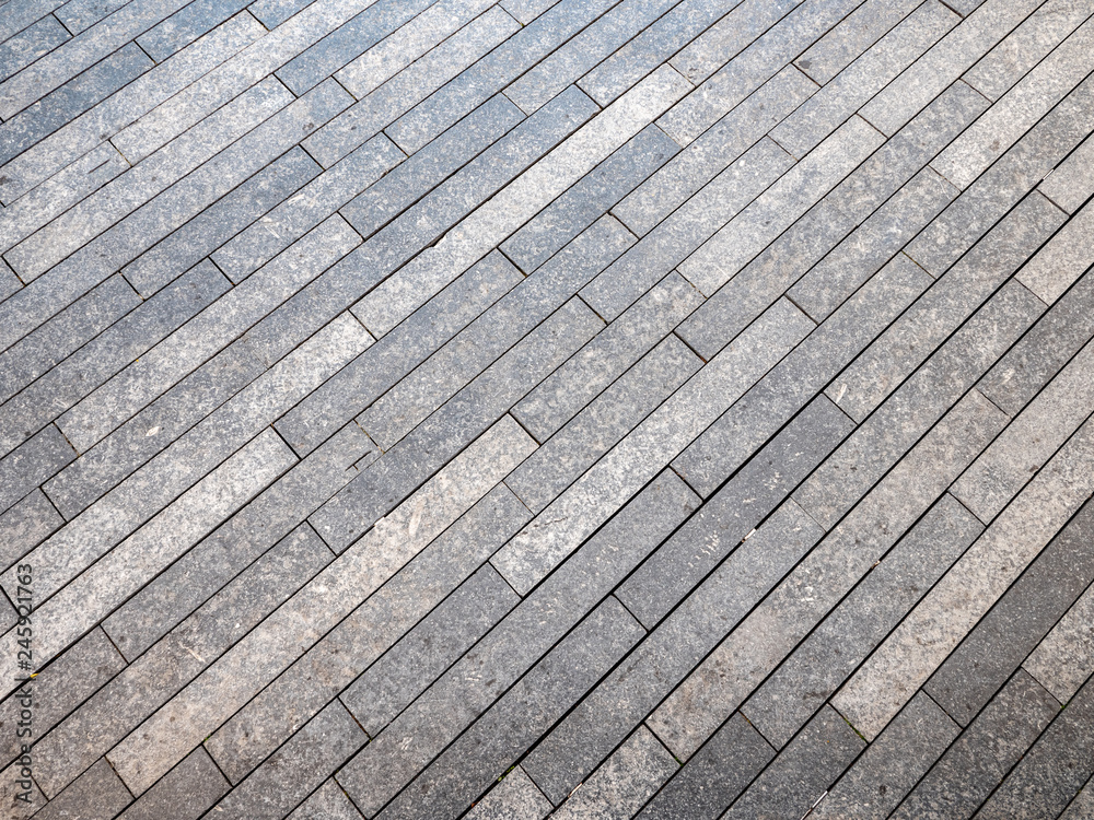 Natural stone granite floor tile pavement. Full frame diagonal lined abstract background texture. Natural stone granite floor tile pavement. Full frame diagonal lined abstract background texture.