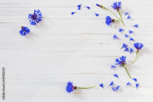 cornflowers on white wooden background
