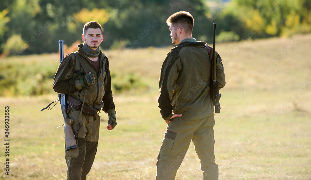 Man hunters with rifle gun. Boot camp. Military uniform fashion. Friendship of men hunters. Army forces. Camouflage. Hunting skills and weapon equipment. How turn hunting into hobby. Future Man hunters with rifle gun. Boot camp. Military uniform fashion. Friendship of men hunters. Army forces. Camouflage. Hunting skills and weapon equipment. How turn hunting into hobby. Future