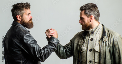 Strong handshake. Friendship of brutal guys. Leadership concept. True friendship of mature friends. Male friendship. Brutal bearded men wear leather jackets shaking hands. Real men and brotherhood photo