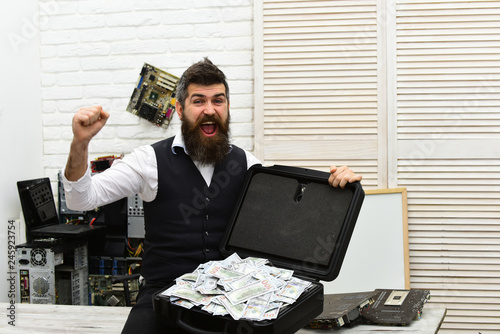 Its a rich mans world. Business man with money case in office. Bearded man with cash money. Bearded hipster with dollar banknotes. Business and making money. Withdrawing cash from electronic money photo