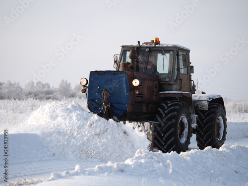 Tver region. Sonkovsky district. Russia. 28 January 2019. Clearing snow from the road. Tractor grader clears snow from the road. © kozorog