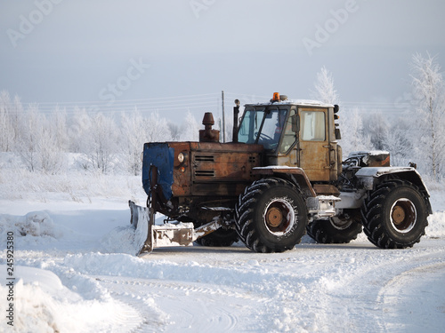 Tver region. Sonkovsky district. Russia. 28 January 2019. Clearing snow from the road. Tractor grader clears snow from the road.