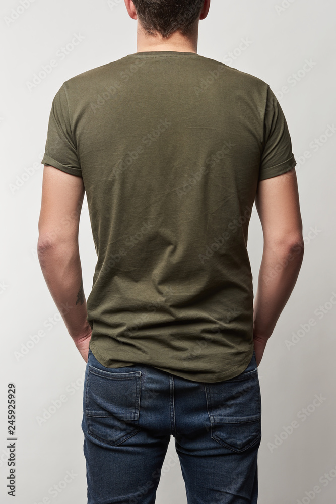 back view of man in khaki t-shirt with copy space isolated on grey back view of man in khaki t-shirt with copy space isolated on grey
