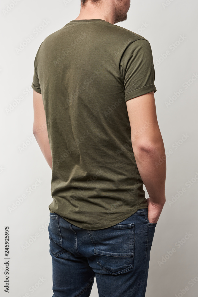 back view of man in khaki t-shirt with copy space isolated on grey back view of man in khaki t-shirt with copy space isolated on grey