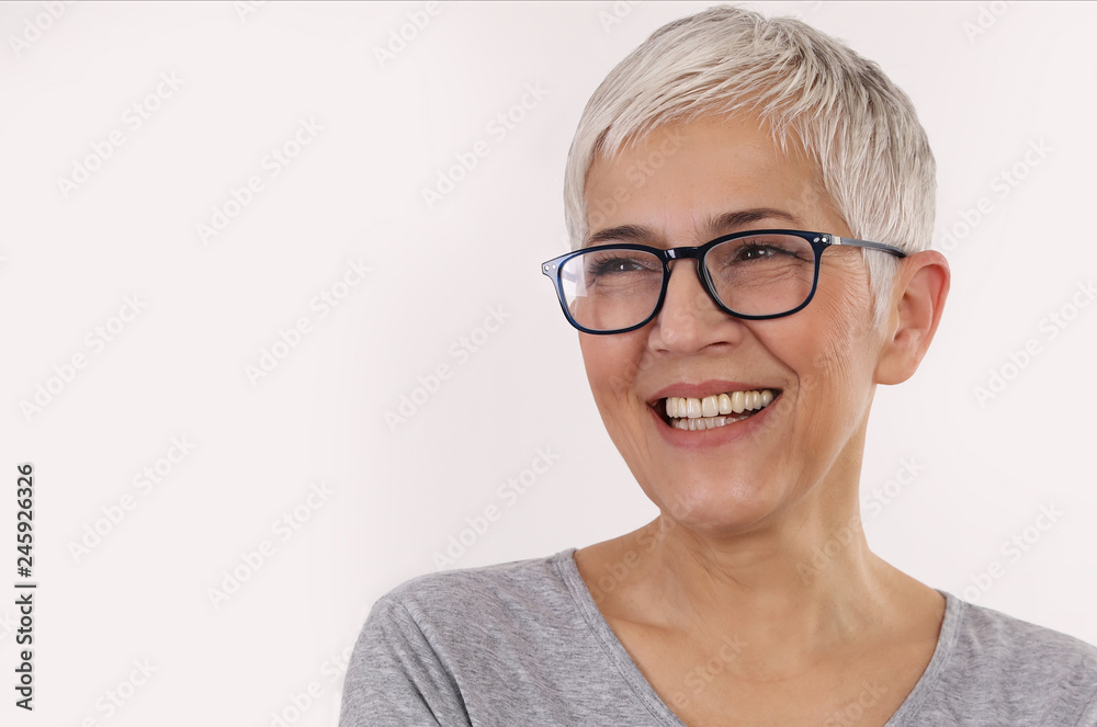 Happy Smiling Senior Woman wering glasses on white background.