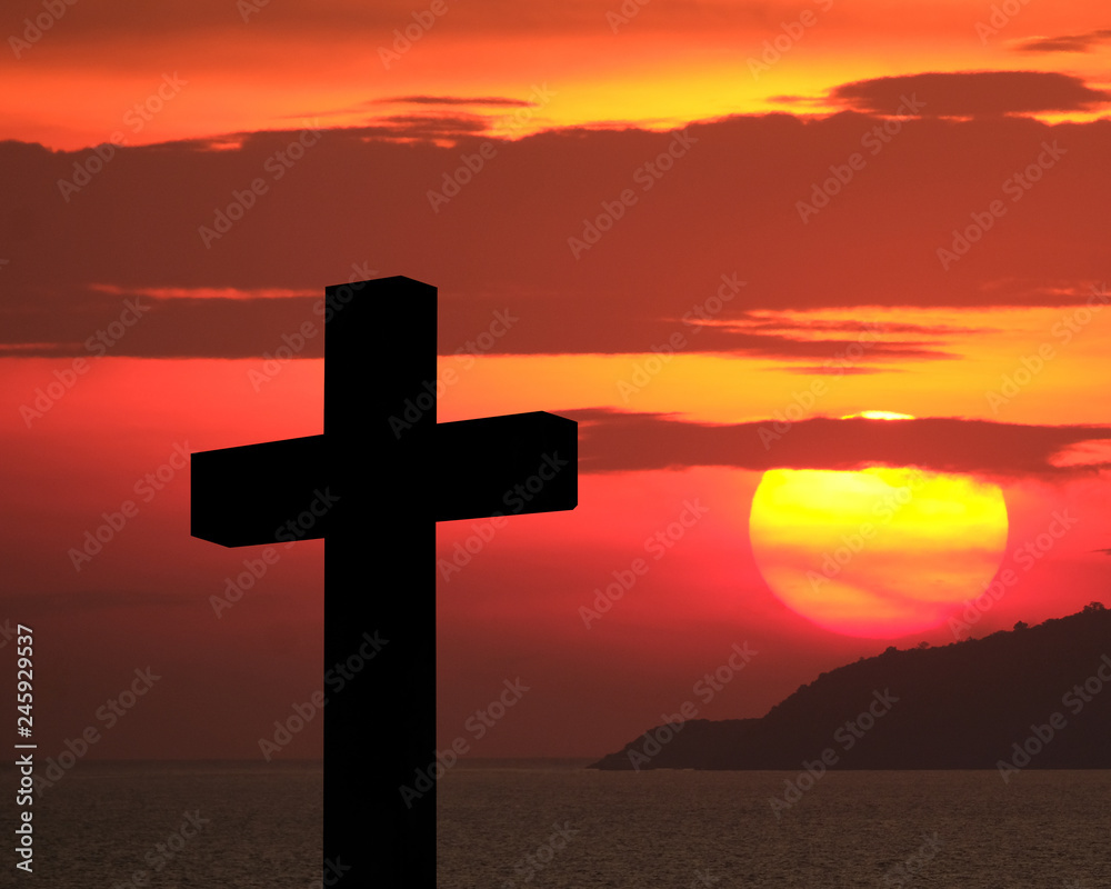 Cross and crucifixion of Jesus Christ silhouette with fiery red dramatic sky and massive glowing large sun over an island during sunset. Religious symbolism, Mourning, memories, remembrance and commem Cross and crucifixion of Jesus Christ silhouette with fiery red dramatic sky and massive glowing large sun over an island during sunset. Religious symbolism, Mourning, memories, remembrance and commem