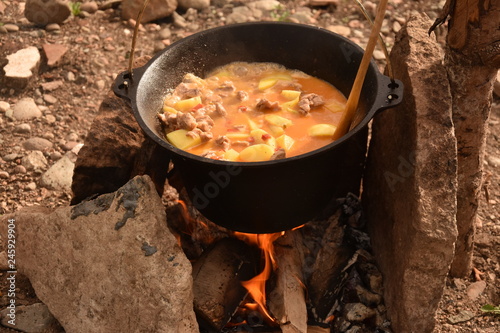 food cooking in stew pot in the nature ,romanian , tocana,traditional ceaun photo
