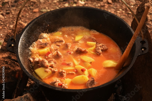 food cooking in stew pot in the nature ,romanian , tocana,traditional ceaun photo
