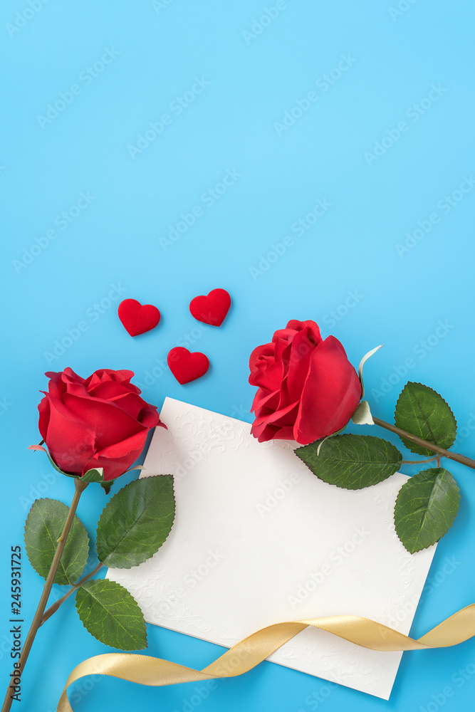 Fototapeta premium Beautiful greeting card with golden ribbon for Valentine's day, anniversary, mother's day and birthday on blue background, copyspace, topview, mockup, flatlay