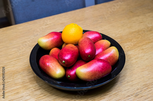Apple mangos, oranges, and lemons in the bowl in the kitchen