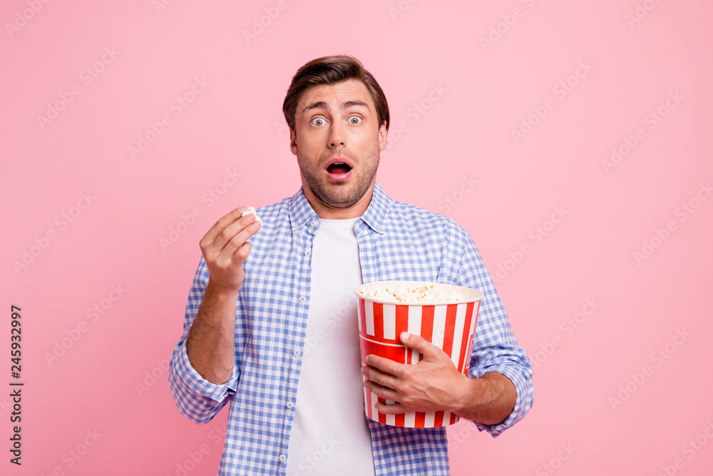 Fototapeta premium Close up photo of beautiful amazing brunet he him his handsome hold pop corn oh no facial expression watching scary movie wearing specs casual checkered plaid shirt outfit isolated on rose background