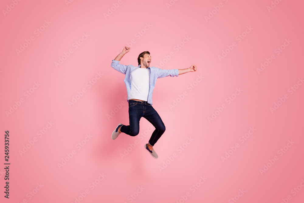 Full length body size photo of jumping high crazy cheer he his him handsome glad about score strike bowling yelling loudly wearing casual jeans checkered plaid shirt isolated on rose background