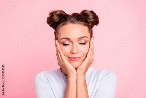 Close-up portrait of her she nice cute lovely attractive fascinating lovable winsome calm girl with buns touching cheeks closed eyes isolated over pink pastel background