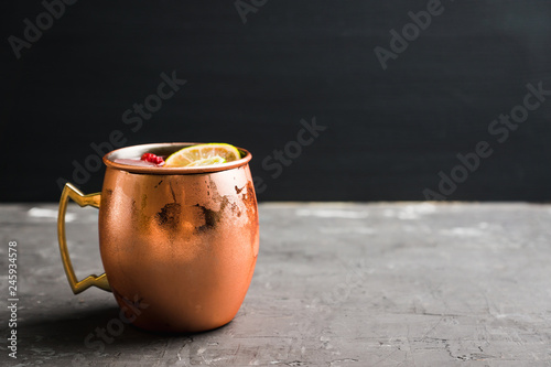 Photography Sweet moscow mule with lime and raspberry in copper mug on the rustic background