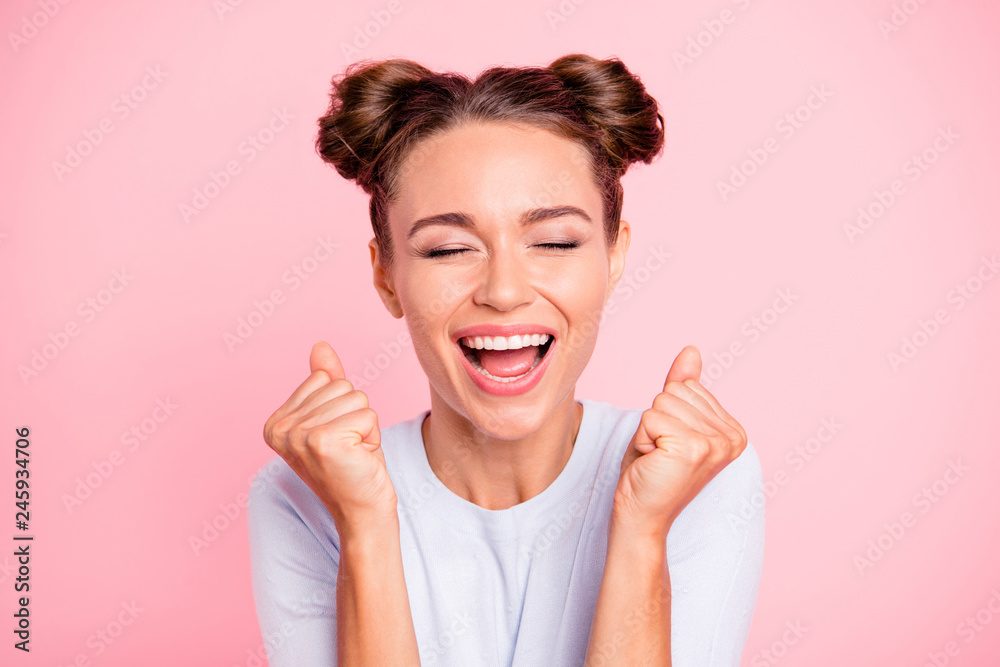 Close-up portrait of her she nice-looking lovely attractive cheerful cheery glad girl with buns holding fists opened mouth isolated over pink pastel background Close-up portrait of her she nice-looking lovely attractive cheerful cheery glad girl with buns holding fists opened mouth isolated over pink pastel background