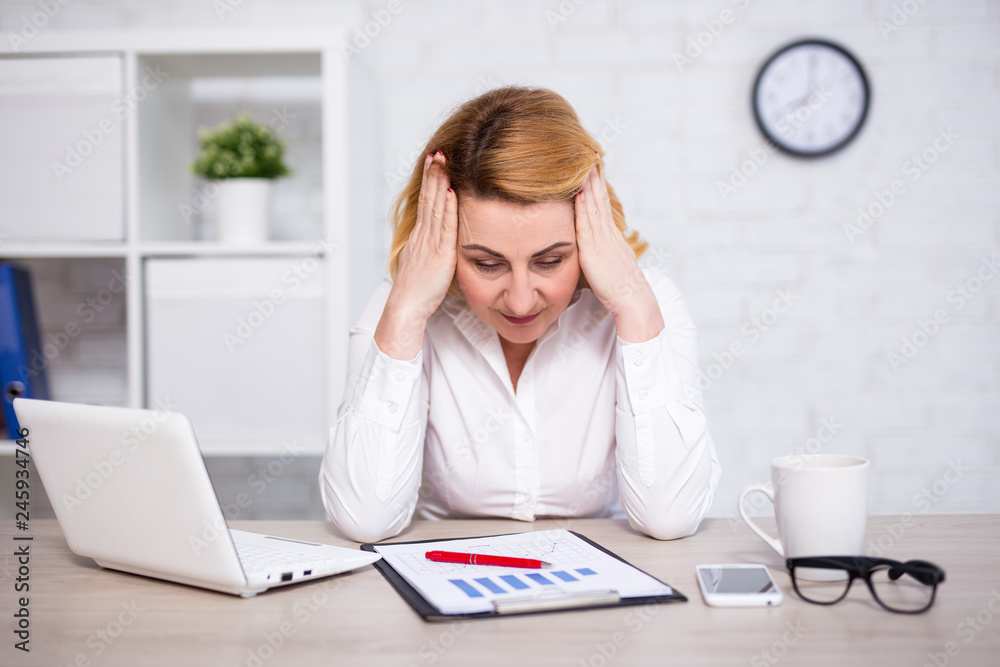 business and bankruptcy concept - portrait of sad or tired mature business woman in office business and bankruptcy concept - portrait of sad or tired mature business woman in office