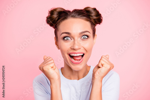 Close-up portrait of her she nice-looking crazy lovely attractive cheerful cheery glad funny girl with buns holding fists opened mouth isolated over pink pastel background