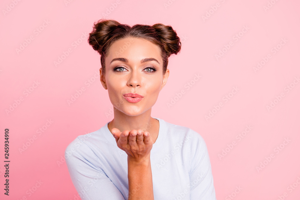 Obraz premium Close-up portrait of her she nice lovely winsome fascinating attractive cheerful flirty girl with buns sending kiss isolated over pink pastel background
