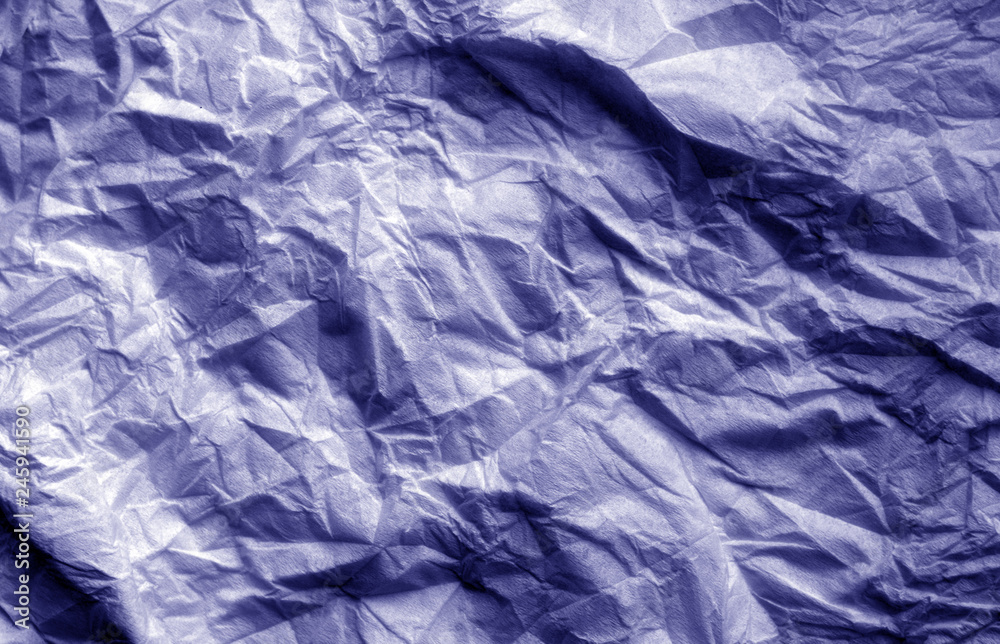 Obraz premium Crumpled sheet of paper in blue color.