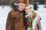 Romantic senior couple walkink in the park in winter time. Love forever
