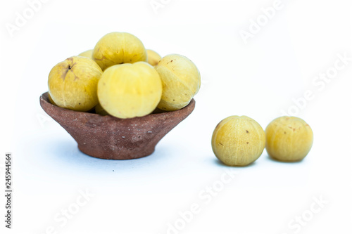 Close up of raw fresh organic popular Indian & Asian fruit isolated on white i.e. Indian gooseberry or Amla or Phyllanthus emblica  or emblic  or emblic myrobalan or myrobalan. photo