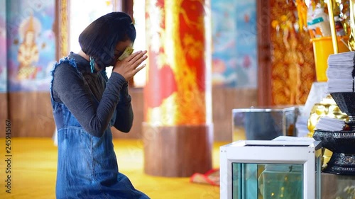 Asian Young Woman Pay Respect to the Buddha in the Temple.