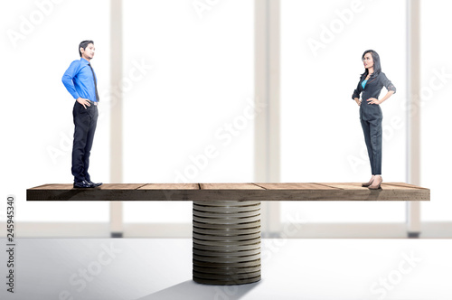 Konstfotografi Asian businessman and businesswoman standing on balancer