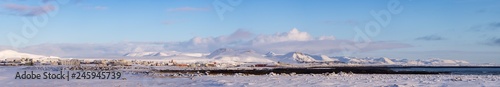 Wide Panorama of Grindavik Town in South Iceland with Snowy Mountains in Background