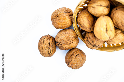 Close up of raw organic Walnut or Juglans or Akhrot or Akharot isolated on white in a hamper. photo